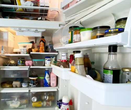 An open refrigerator that is filled with food.